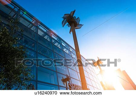 Stock Image - Miniature windmills next to shopping centre, Manchester, UK. Fotosearch