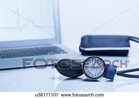 Modern cardiology. Blood pressure gauge with a laptop computer displaying an ECG trace View Large Photo Image Stock Photo - Modern cardiology. Blood pressure gauge with a laptop computer displaying an ECG trace. Fotosearch