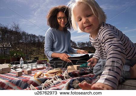 Mother and son on picnic blanket View Large Photo Image Stock Image - Mother and son on picnic blanket. Fotosearch