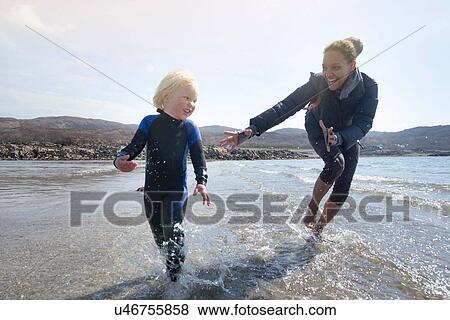 Mother and son running on beach, Loch Eishort, Isle of Skye, Hebrides, Scotland View Large Photo Image Stock Photo - Mother and son running on beach, Loch Eishort, Isle of Skye, Hebrides, Scotland. Fotosearch