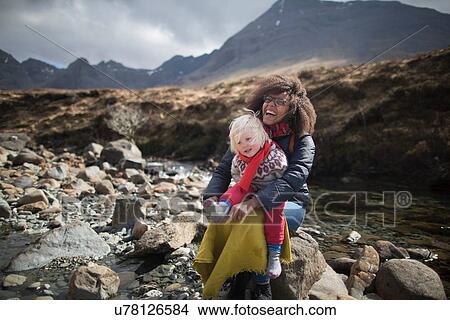 Picture - Mother and son sitting on rocks, Fairy Pools, Isle of Skye, Hebrides, Scotland. Fotosearch