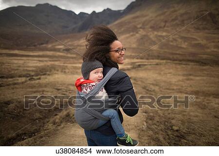 Mother carrying son in sling, Fairy Pools, near Glenbrittle, Isle of Skye, Hebrides, Scotland View Large Photo Image Picture - Mother carrying son in sling, Fairy Pools, near Glenbrittle, Isle of Skye, Hebrides, Scotland. Fotosearch