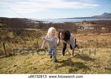 Mother chasing son in field, Isle of Skye, Hebrides, Scotland View Large Photo Image Stock Image - Mother chasing son in field, Isle of Skye, Hebrides, Scotland. Fotosearch