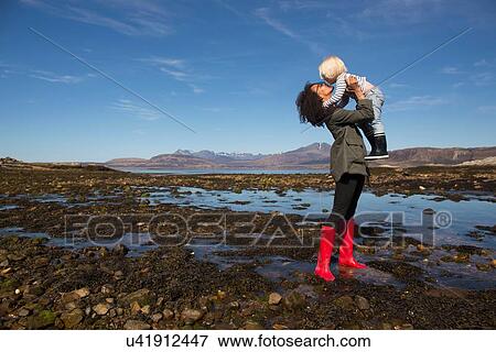 Mother holding son by Loch Eishort, Isle of Skye, Hebrides, Scotland View Large Photo Image Stock Photo - Mother holding son by Loch Eishort, Isle of Skye, Hebrides, Scotland. Fotosearch