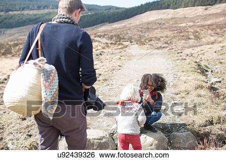Mother photographing son with father View Large Photo Image Stock Photograph - Mother photographing son with father. Fotosearch