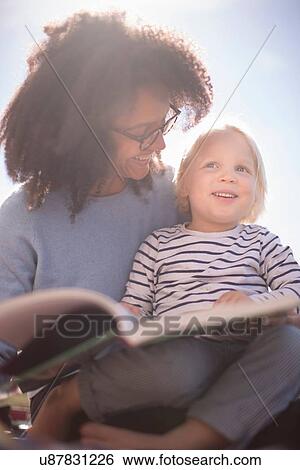 Stock Photograph - Mother reading with son. Fotosearch