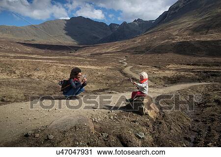 Mother taking photo of son, Fairy Pools, Isle of Skye, Hebrides, Scotland View Large Photo Image Stock Image - Mother taking photo of son, Fairy Pools, Isle of Skye, Hebrides, Scotland. Fotosearch