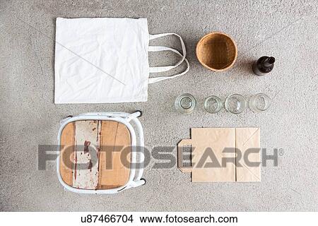 Overhead still life of stool, reusable shopping bag and recyclable paper and bottles View Large Photo Image Picture - Overhead still life of stool, reusable shopping bag and recyclable paper and bottles. Fotosearch