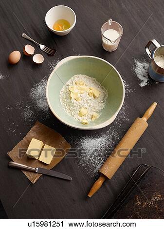 Stock Image - Overhead view of baking table with mixing bowl. Fotosearch