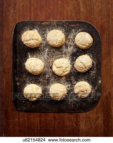 Picture - Overhead view of freshly baked scones on baking tray. Fotosearch