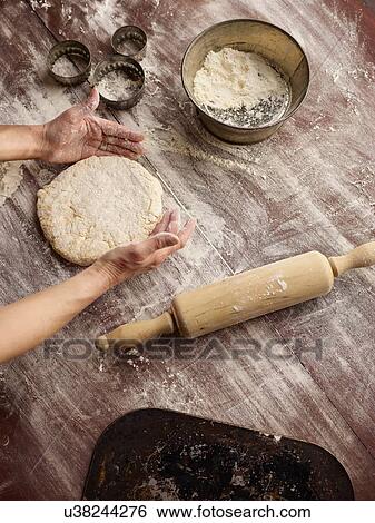 Overhead view of womans hands shaping scone dough View Large Photo Image Stock Photograph - Overhead view of womans hands shaping scone dough. Fotosearch