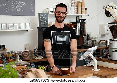 Portrait of cafe waiter serving coffee from counter View Large Photo Image Stock Image - Portrait of cafe waiter serving coffee from counter. Fotosearch