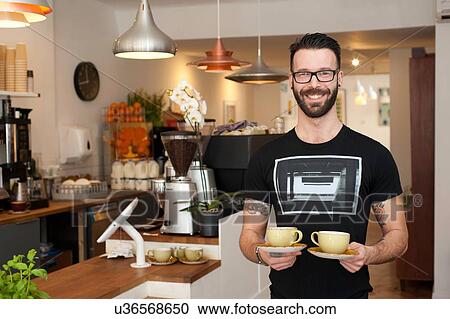 Portrait of cafe waiter serving cups of coffee View Large Photo Image Stock Image - Portrait of cafe waiter serving cups of coffee. Fotosearch