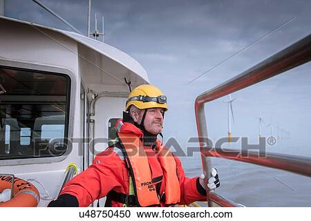 Portrait of engineer on boat at offshore windfarm View Large Photo Image Stock Image - Portrait of engineer on boat at offshore windfarm. Fotosearch