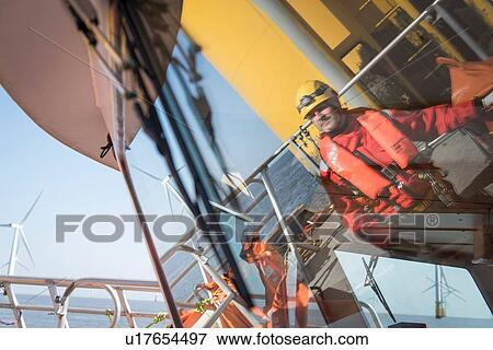 Portrait of engineer reflected in windscreen of service boat at offshore windfarm View Large Photo Image Stock Photo - Portrait of engineer reflected in windscreen of service boat at offshore windfarm. Fotosearch