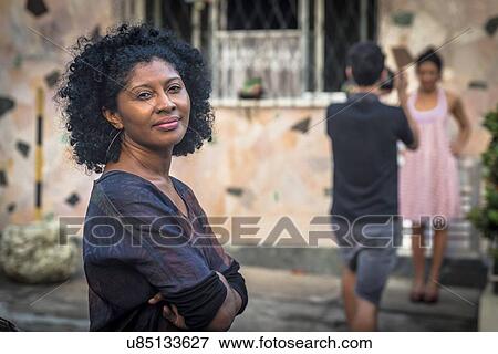 Portrait of fashion shoot assistant smiling and looking at camera View Large Photo Image Stock Photo - Portrait of fashion shoot assistant smiling and looking at camera. Fotosearch