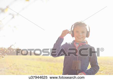 Portrait of girl metal detecting in field holding up silver coin View Large Photo Image Stock Photography - Portrait of girl metal detecting in field holding up silver coin. Fotosearch