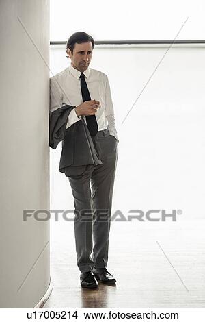 Portrait of mature businessman, leaning on pillar, looking away View Large Photo Image Picture - Portrait of mature businessman, leaning on pillar, looking away. Fotosearch