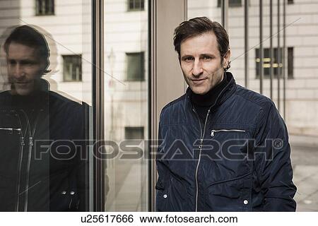 Stock Photograph - Portrait of mature man beside office building. Fotosearch