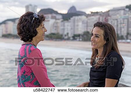 Portrait of mature woman and mother face to face at beach, Copacabana, Rio de Janeiro, Brazil View Large Photo Image Stock Photo - Portrait of mature woman and mother face to face at beach, Copacabana, Rio de Janeiro, Brazil. Fotosearch