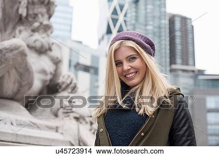 Picture - Portrait of smiling young woman on street, New York, USA. Fotosearch