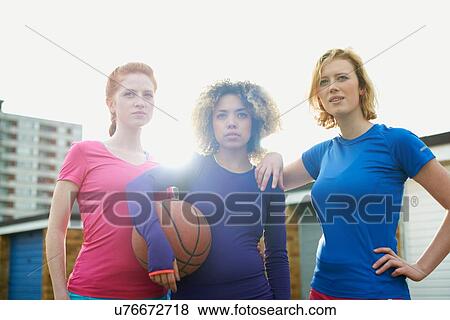 Portrait of three women exercising together holding a basketball View Large Photo Image Stock Photo - Portrait of three women exercising together holding a basketball. Fotosearch