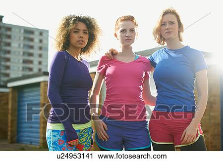 Portrait of three women standing together wearing sports clothing View Large Photo Image Stock Image - Portrait of three women standing together wearing sports clothing. Fotosearch
