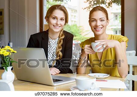 Portrait of two young women drinking coffee in cafe View Large Photo Image Stock Photography - Portrait of two young women drinking coffee in cafe. Fotosearch