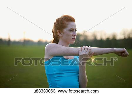 Portrait of woman warming up to exercise in the park View Large Photo Image Stock Image - Portrait of woman warming up to exercise in the park. Fotosearch
