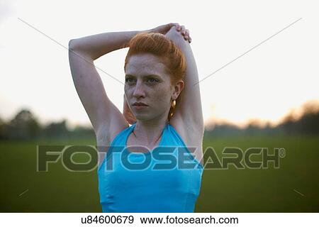 Portrait of woman warming up to exercise in the park View Large Photo Image Stock Photo - Portrait of woman warming up to exercise in the park. Fotosearch