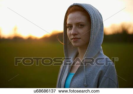 Portrait of woman with hood up after exercising in the park View Large Photo Image Stock Photo - Portrait of woman with hood up after exercising in the park. Fotosearch