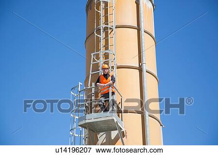 Portrait of worker on smoke stack viewing platform View Large Photo Image Stock Photo - Portrait of worker on smoke stack viewing platform. Fotosearch