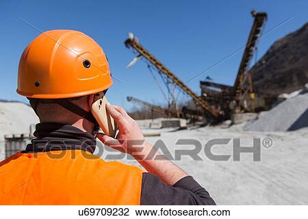 Portrait of worker wearing protective workwear in front of wooden door View Large Photo Image Stock Image - Portrait of worker wearing protective workwear in front of wooden door. Fotosearch