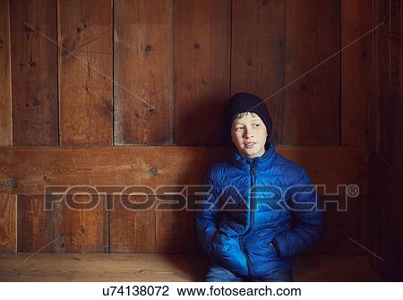 Portrait of young boy sitting in wooden shelter View Large Photo Image Stock Image - Portrait of young boy sitting in wooden shelter. Fotosearch