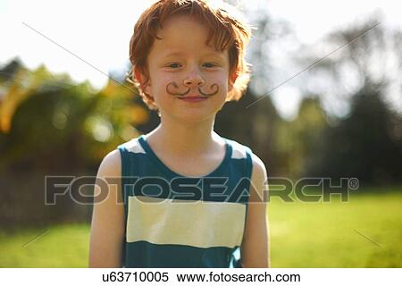 Stock Photography - Portrait of young boy with drawn on moustache. Fotosearch