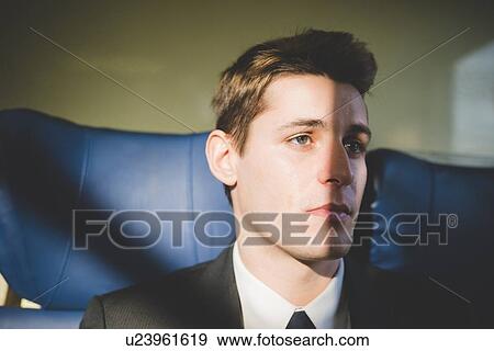 Portrait of young businessman commuter on train. View Large Photo Image Stock Photo - Portrait of young businessman commuter on train.. Fotosearch