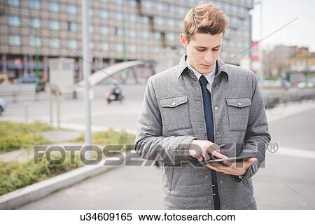 Portrait of young businessman commuter using digital tablet. View Large Photo Image Stock Photography - Portrait of young businessman commuter using digital tablet.. Fotosearch