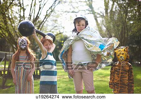 Portrait of young children wearing fancy dress, outdoors View Large Photo Image Picture - Portrait of young children wearing fancy dress, outdoors. Fotosearch
