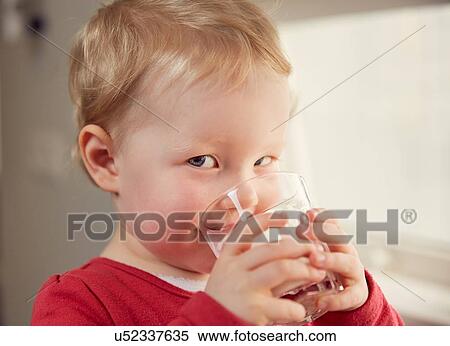 Stock Photography - Portrait of young girl drinking from glass. Fotosearch