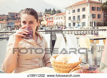 Portrait of young woman drinking water at lakeside restaurant, Lake Mergozzo, Verbania, Piemonte, Italy View Large Photo Image Stock Image - Portrait of young woman drinking water at lakeside restaurant, Lake Mergozzo, Verbania, Piemonte, Italy. Fotosearch