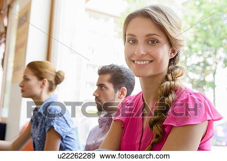 Portrait of young woman in cafe with friends View Large Photo Image Stock Photo - Portrait of young woman in cafe with friends. Fotosearch