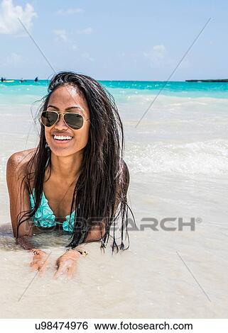 Portrait of young woman lying in sea on Kailua beach, Oahu, Hawaii, USA View Large Photo Image Stock Photograph - Portrait of young woman lying in sea on Kailua beach, Oahu, Hawaii, USA. Fotosearch