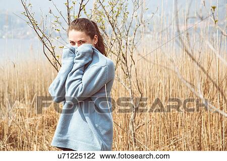 Portrait of young woman wearing blue sweater on lakeside, Lake Mergozzo, Verbania, Piemonte, Italy View Large Photo Image Stock Image - Portrait of young woman wearing blue sweater on lakeside, Lake Mergozzo, Verbania, Piemonte, Italy. Fotosearch