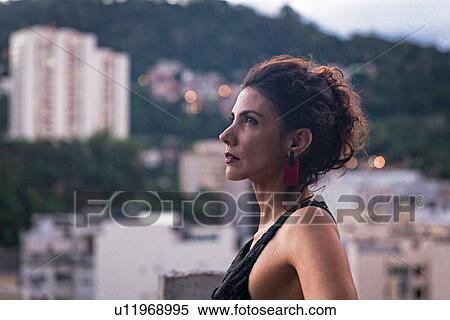 Profile portrait of fashion model wearing black dress and looking up View Large Photo Image Stock Photography - Profile portrait of fashion model wearing black dress and looking up. Fotosearch