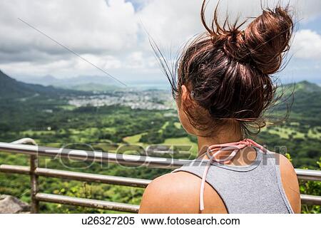 Rear view close up of young woman looking out at landscape, Nuuanu Pali, Oahu, Hawaii, USA View Large Photo Image Stock Photography - Rear view close up of young woman looking out at landscape, Nuuanu Pali, Oahu, Hawaii, USA. Fotosearch