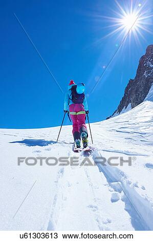 Rear view of mature female skier moving up Mont Blanc massif, Graian Alps, France View Large Photo Image Stock Image - Rear view of mature female skier moving up Mont Blanc massif, Graian Alps, France. Fotosearch