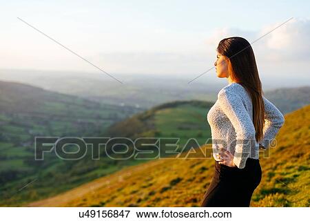 Rear view of young woman looking out over Glyn Collwn valley, Brecon Beacons, Powys, Wales View Large Photo Image Stock Photo - Rear view of young woman looking out over Glyn Collwn valley, Brecon Beacons, Powys, Wales. Fotosearch