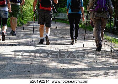Rear waist down view of mature hikers on rural road, Grigna, Lecco, Lombardy, Italy View Large Photo Image Picture - Rear waist down view of mature hikers on rural road, Grigna, Lecco, Lombardy, Italy. Fotosearch