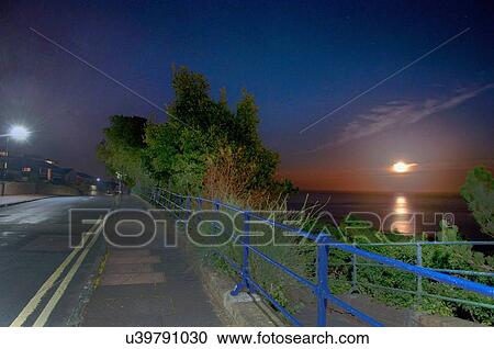 Stock Image - Road leading to sea, Eastbourne, East Sussex, UK. Fotosearch