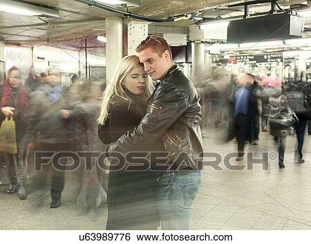 Stock Photograph - Romantic young couple hugging in New York City subway station, New York, USA. Fotosearch